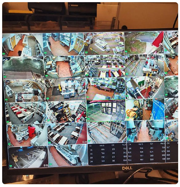 Surveillance camera monitor displaying multiple camera feeds from a restaurant, showcasing various interior views and activity areas, highlighting the comprehensive security upgrades by SAV Systems.