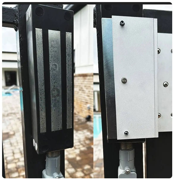 Access control system hardware installed on a gate, featuring a black and silver design with visible mounting screws, highlighting security measures for child entry points at a facility.