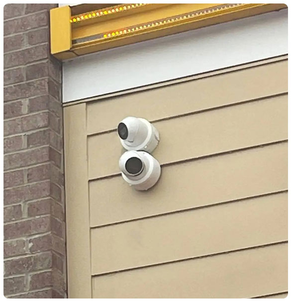 Surveillance cameras installed on the exterior wall of a building, enhancing security for the Golden Corral restaurant project by SAV Systems.