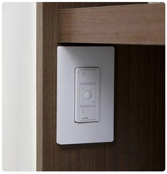 Lutron control panel installed on wooden wall, part of integrated technology upgrade for Ponce Dental Studio's advanced lighting and operational efficiency.