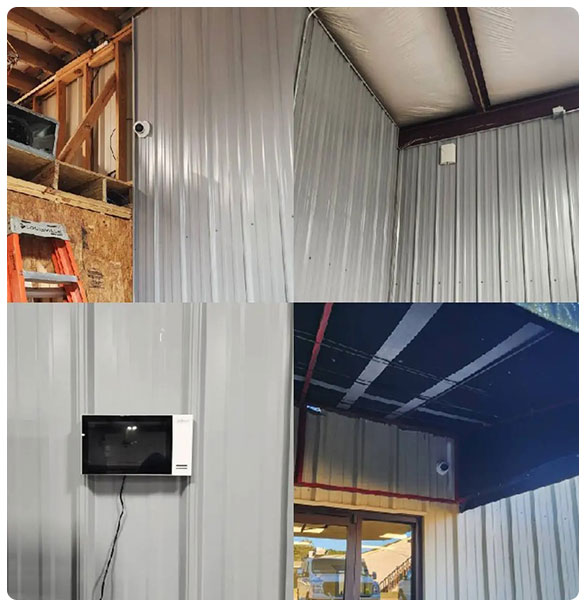 Installation of security cameras and a monitor in a newly constructed motorsport workshop, featuring metal walls and a focus on advanced security and networking solutions.
