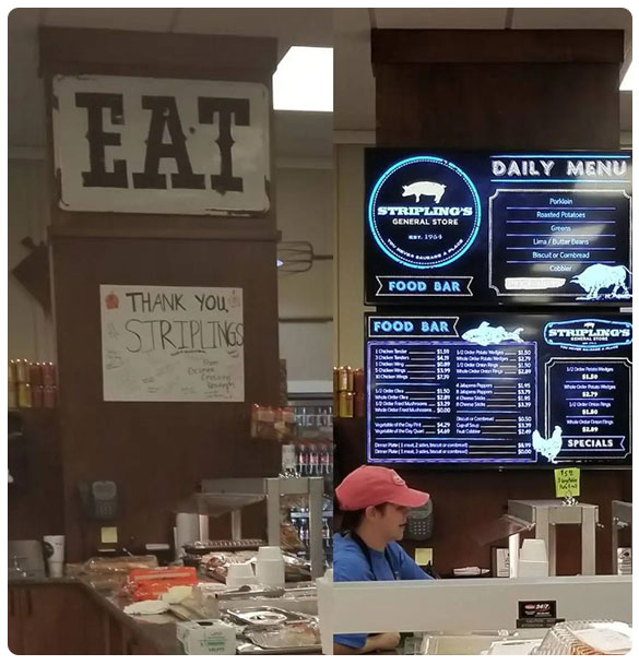 Signage reading "EAT" and "THANK YOU STRIPLINGS," with a menu display for Stripling's General Store featuring daily specials and food bar prices, alongside a staff member in a blue shirt and red hat serving customers.