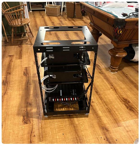 Multi-zone audio equipment rack showcasing organized components for home audio systems, emphasizing seamless integration for personalized sound experiences throughout residential spaces.